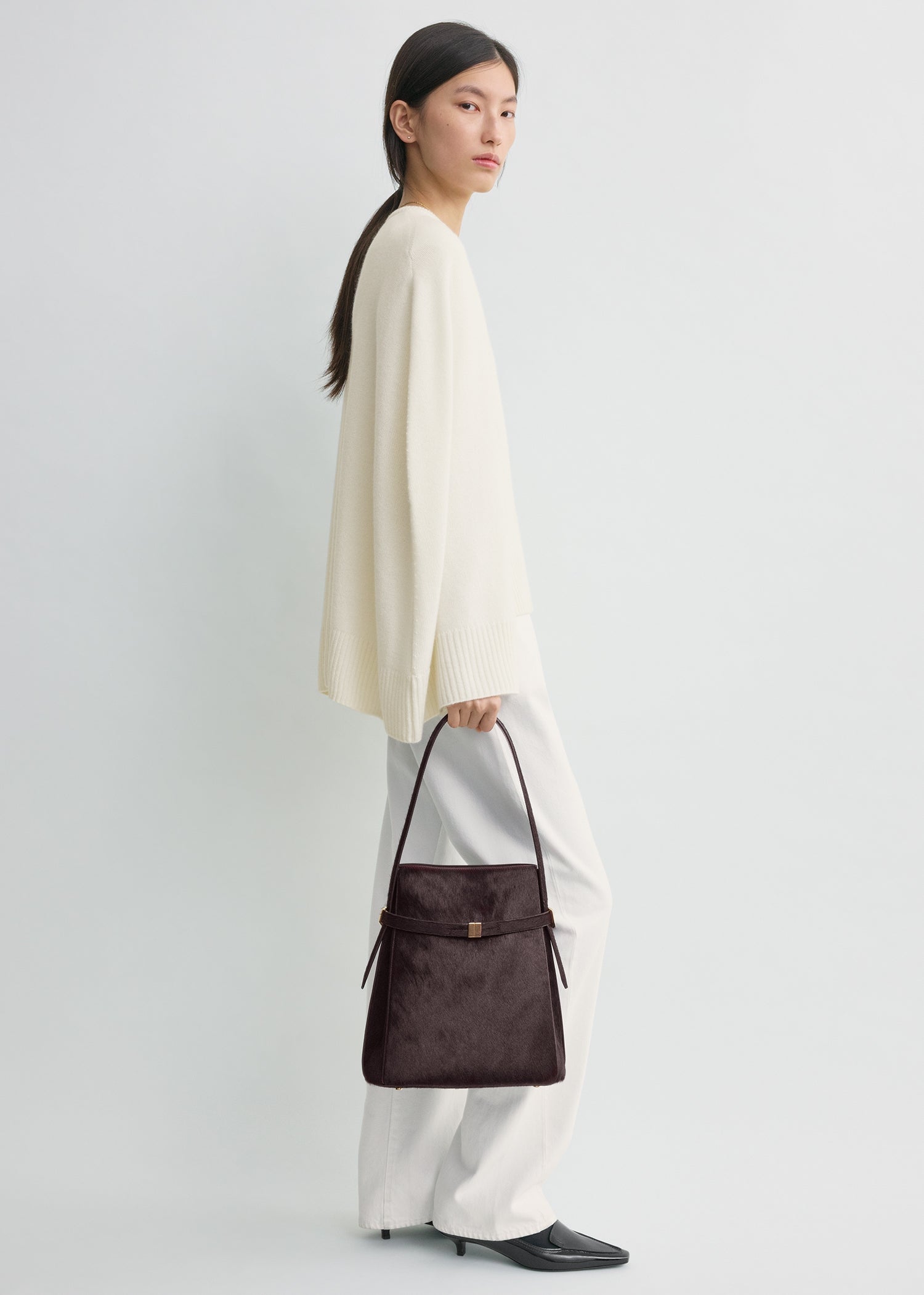 Belted pony hair bucket bag wine
