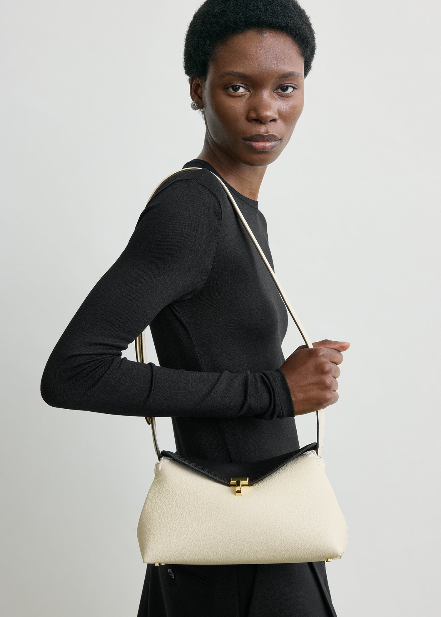 T-lock embroidered leather clutch black/milk