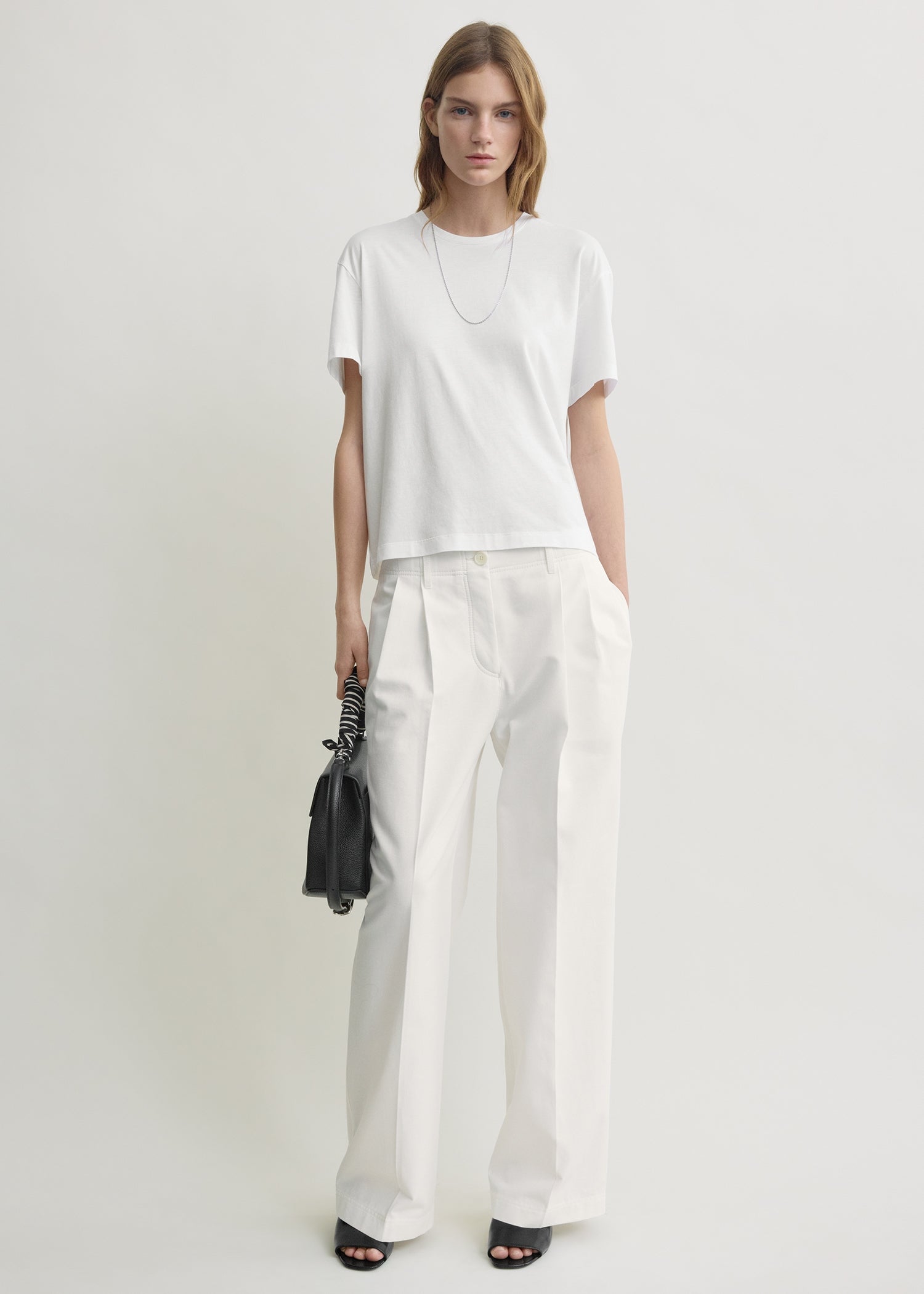 Relaxed chino trousers white from Toteme - $460