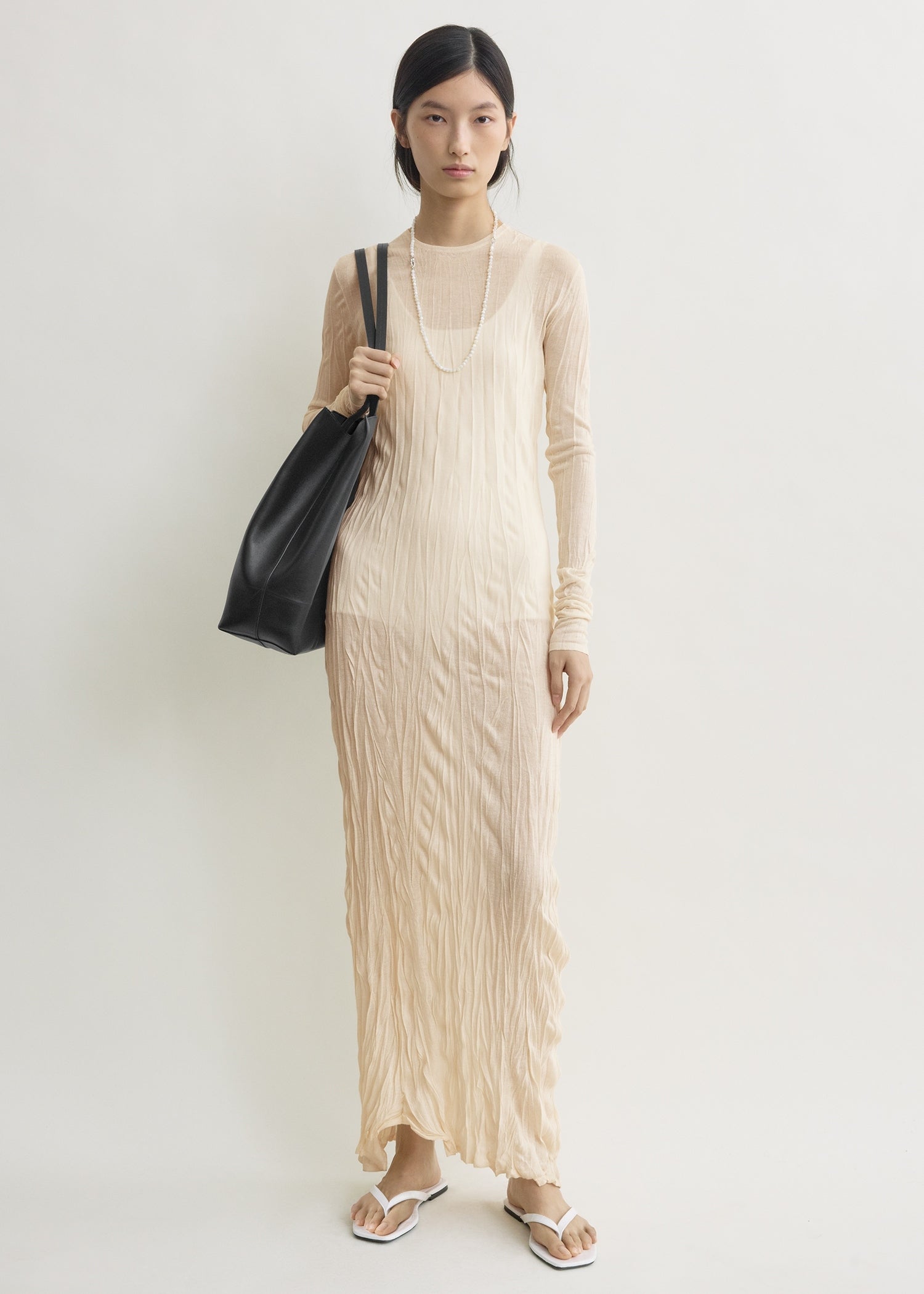 Crinkled knit long-sleeve dress pale apricot from Toteme - $720