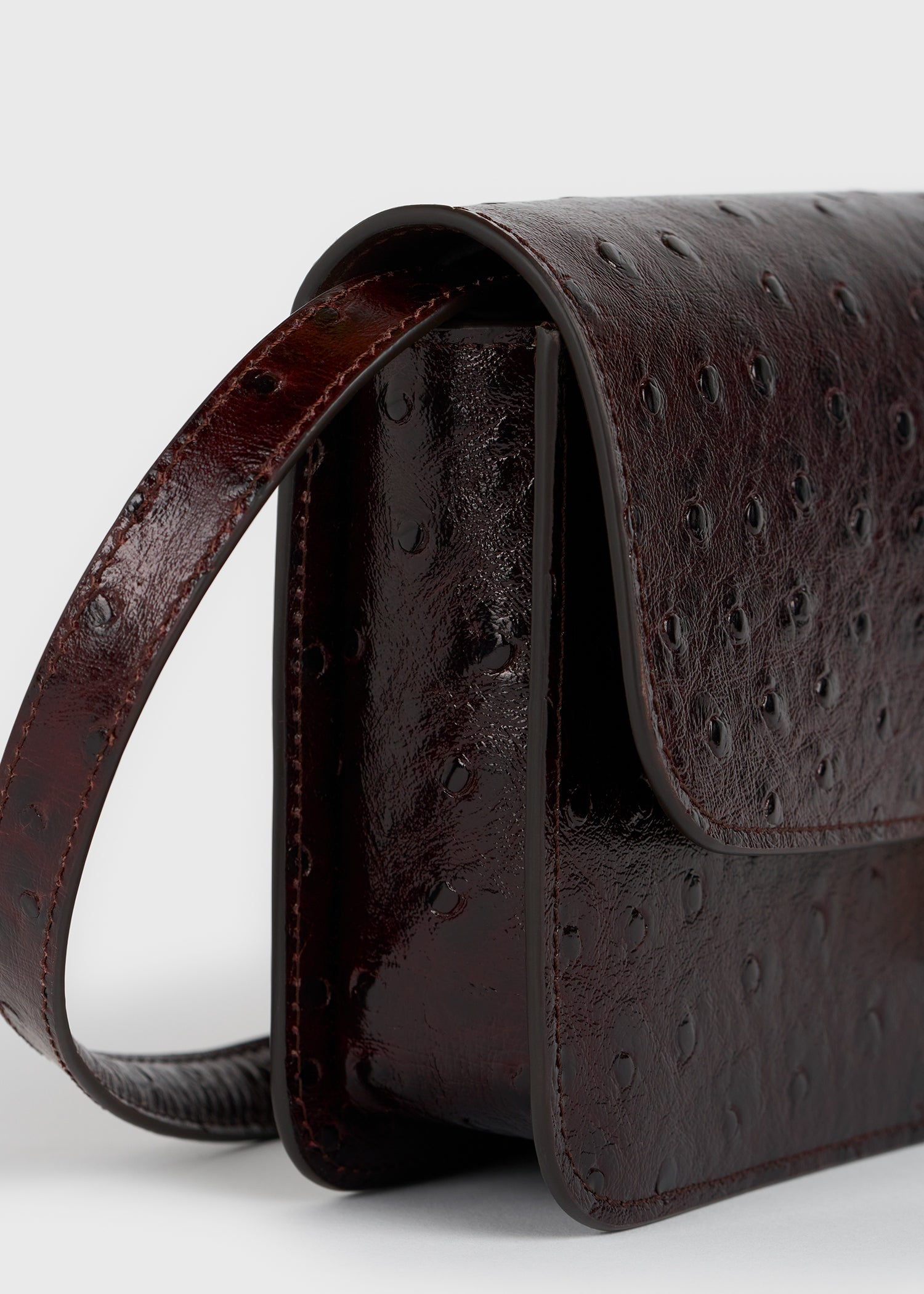 T-lock ostrich-embossed crossbody bordeaux