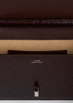 T-lock ostrich-embossed crossbody bordeaux