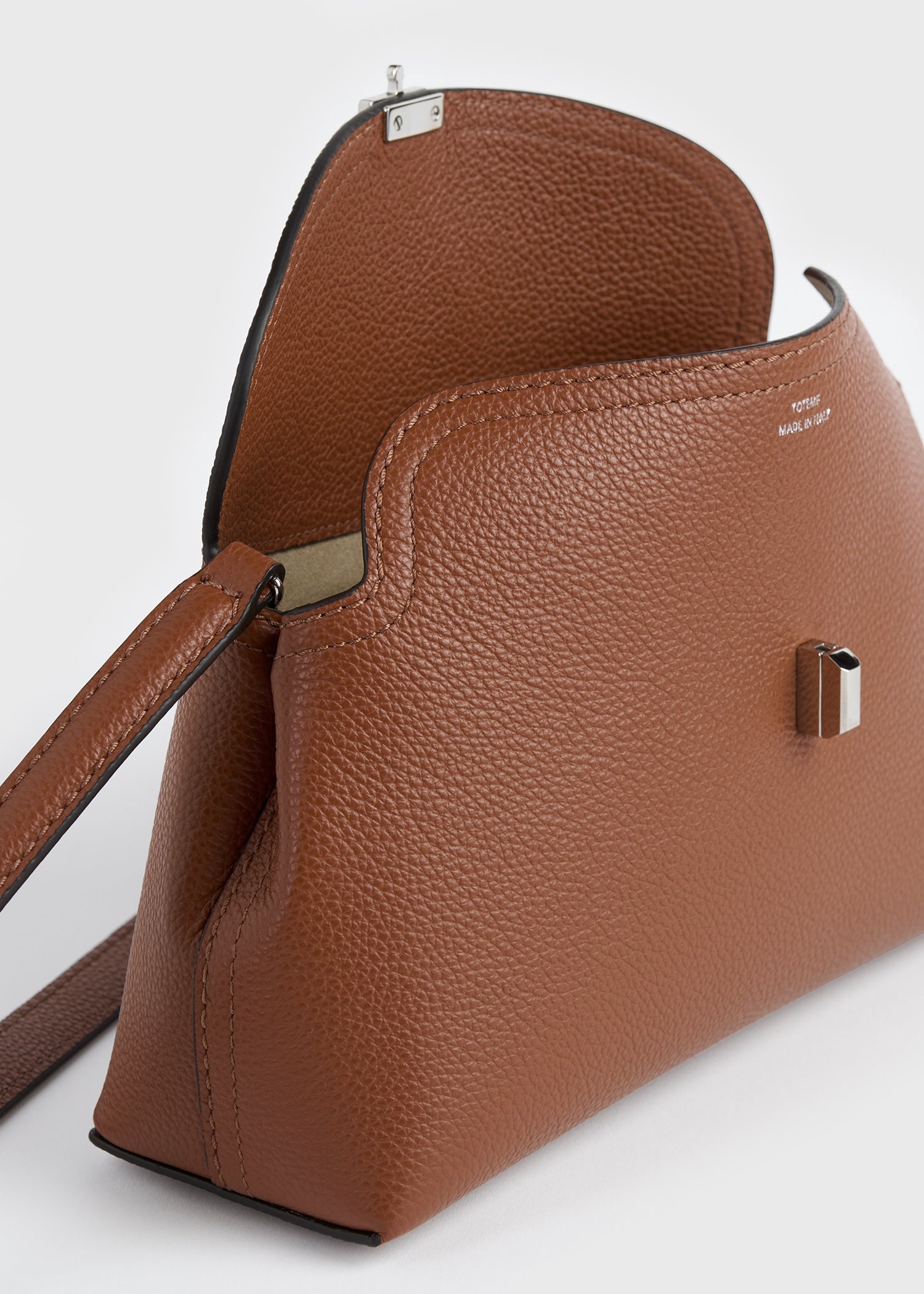 T-lock grained-leather clutch sienna – TOTEME