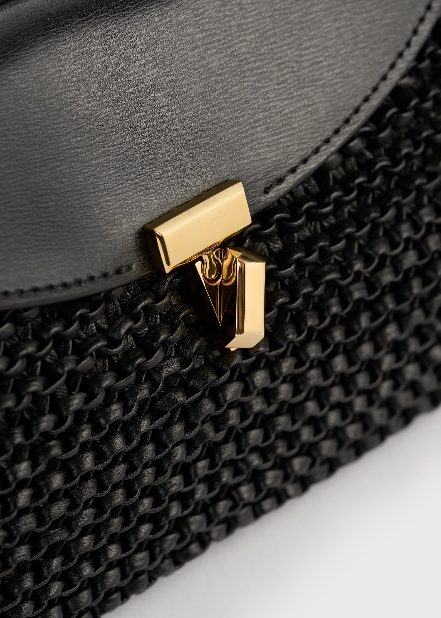 Mini T-lock woven-leather clutch black – TOTEME