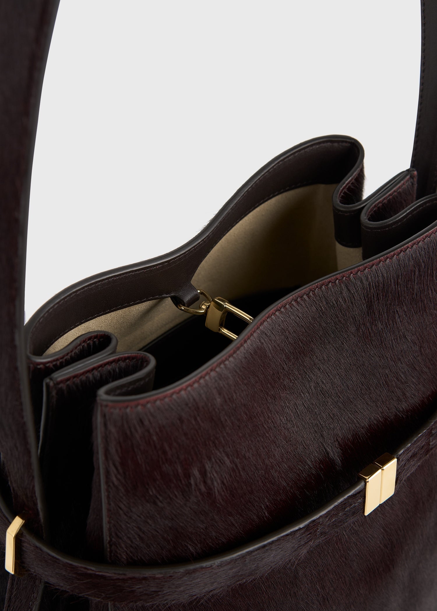 Belted pony hair bucket bag wine