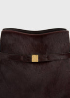 Belted pony hair bucket bag wine