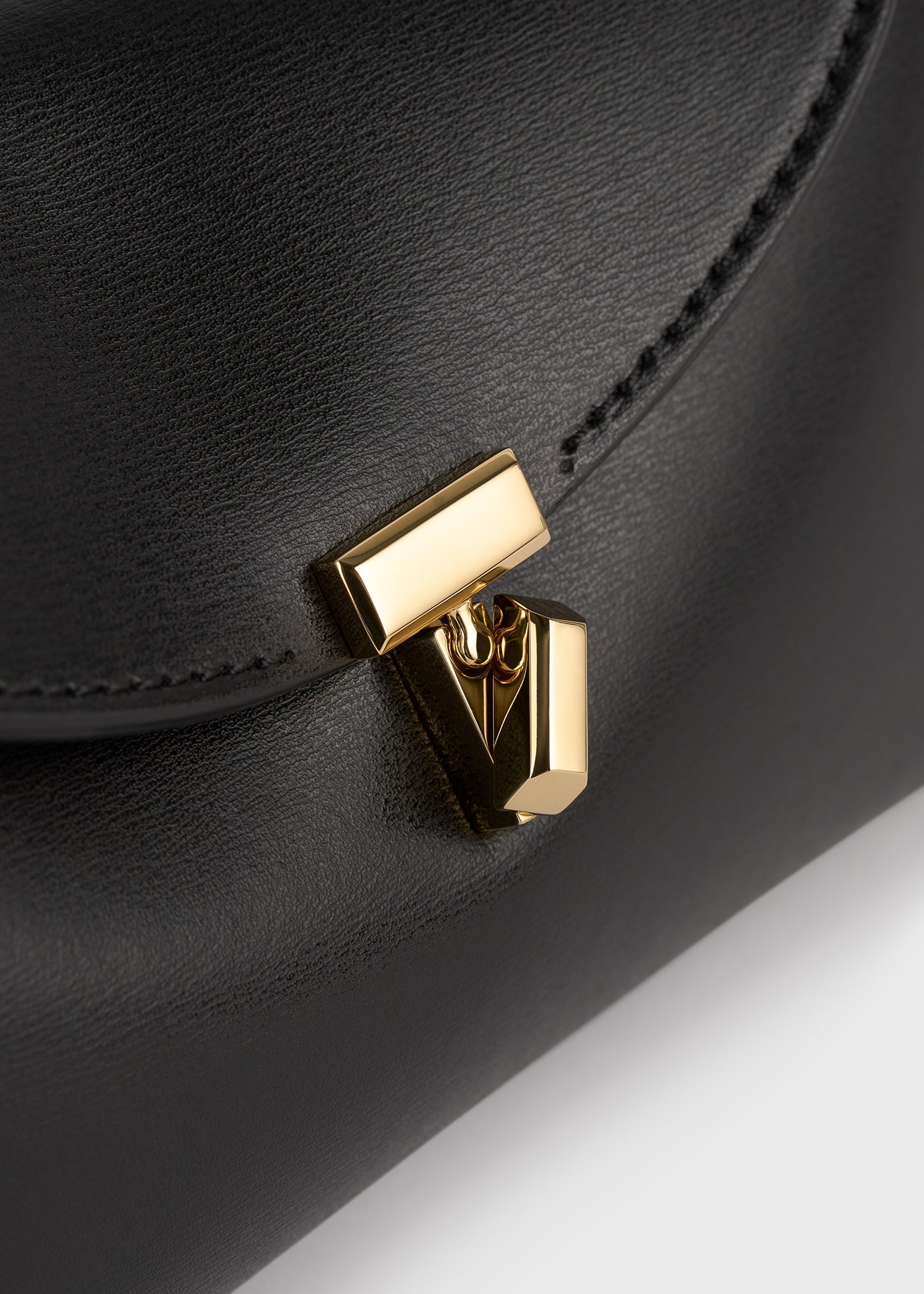 Mini T-lock leather clutch black – TOTEME