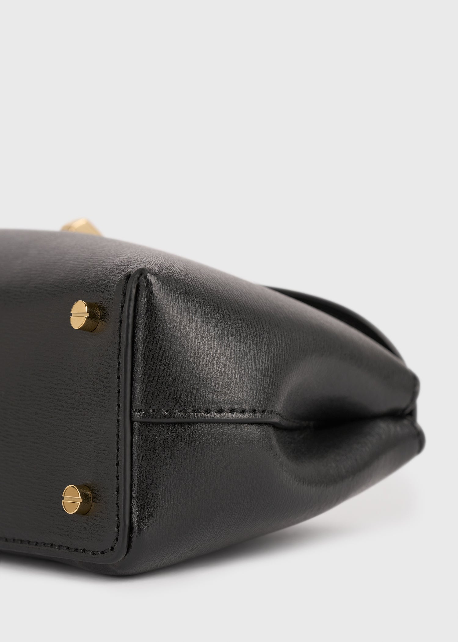 Mini T-lock leather clutch black – TOTEME