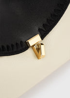 T-lock embroidered leather clutch black/milk