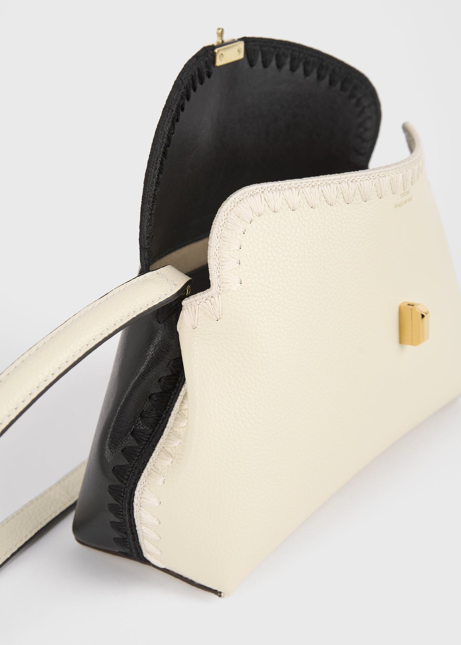 T-lock embroidered leather clutch black/milk