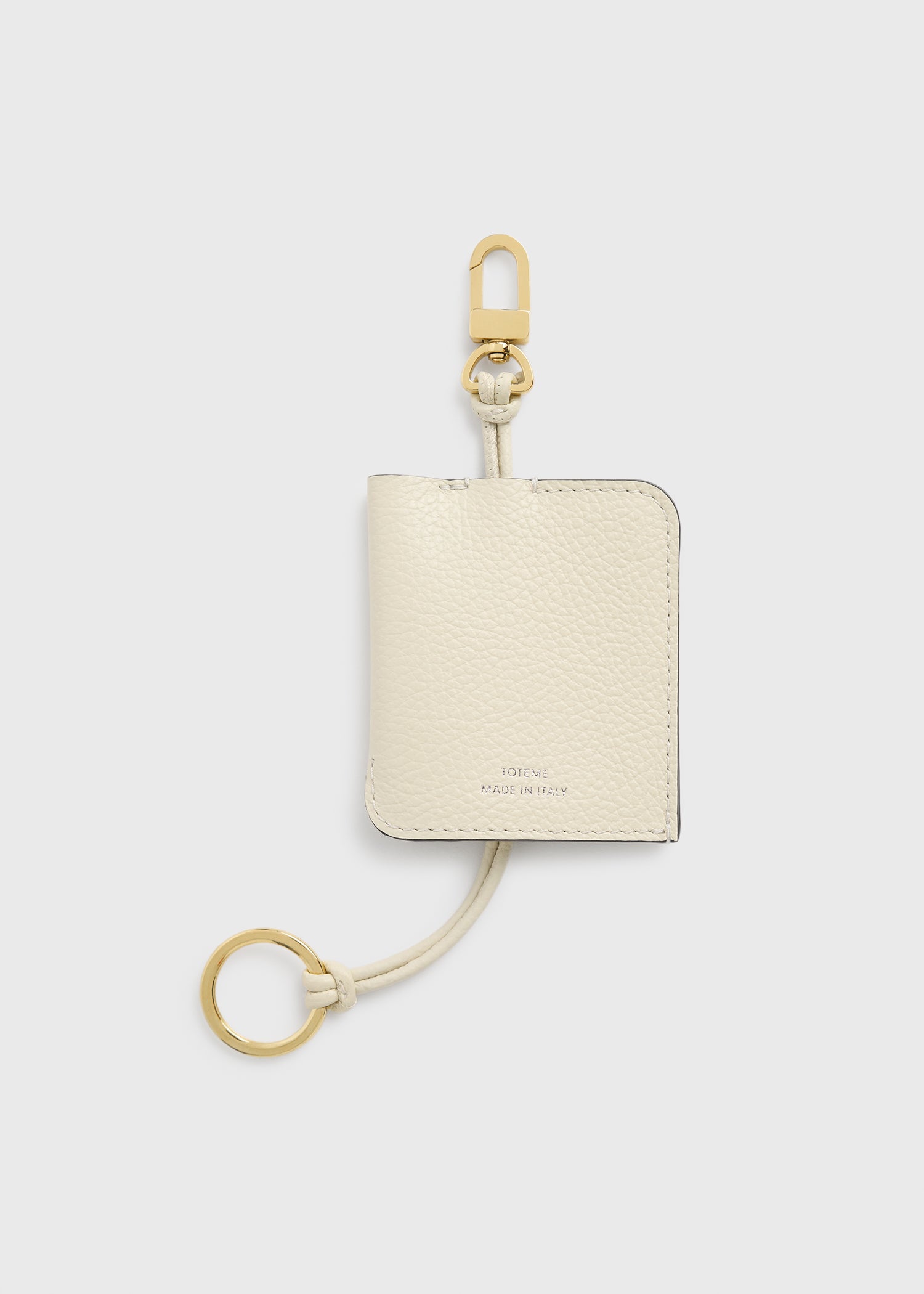 Grained-leather keyring milk from Toteme - $150