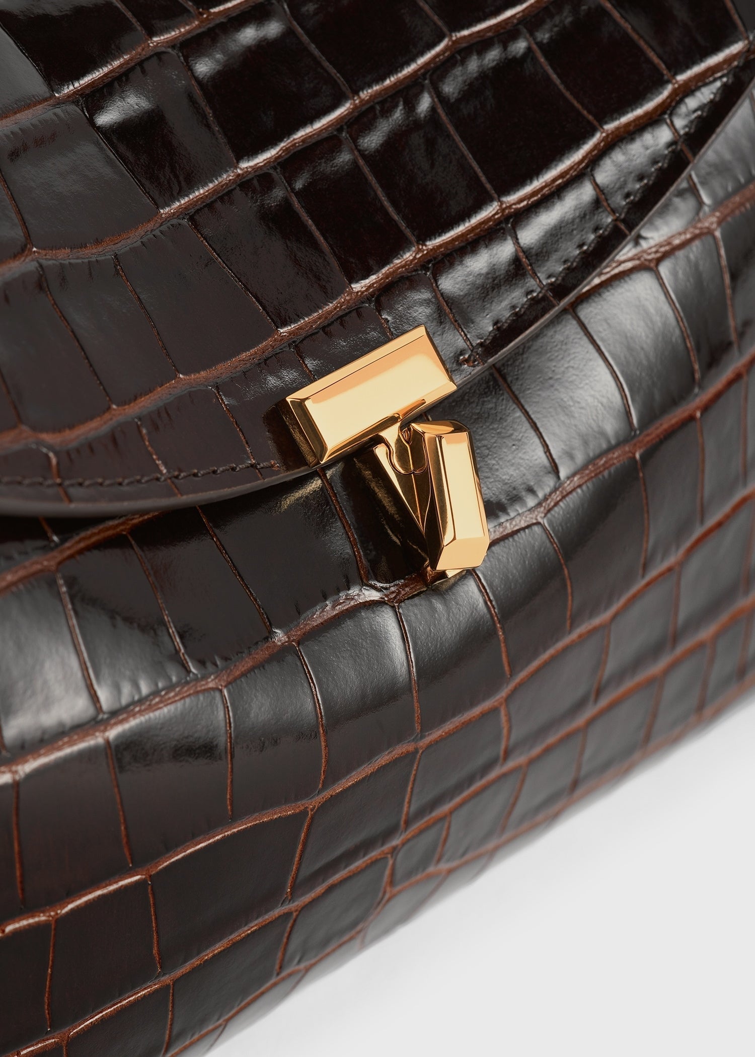 T-lock croco-embossed clutch dark brown