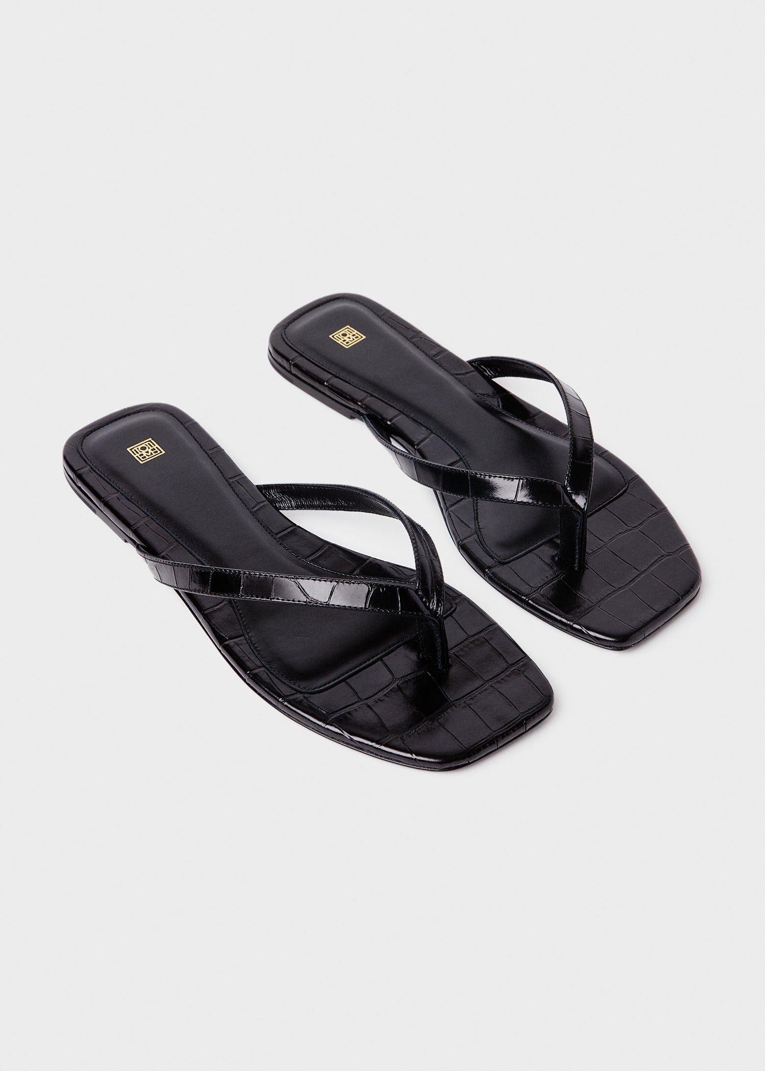 Croco-embossed flip flops black
